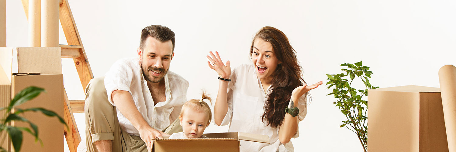 Familie der sidder i flytterod, den lille pige sidder i en flyttekasse