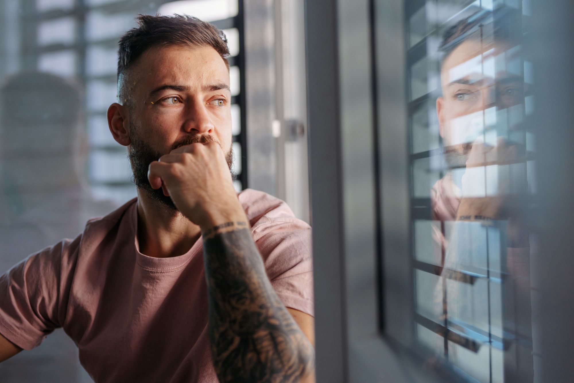 Mand ser trist ud og kigger ud ad vinduet